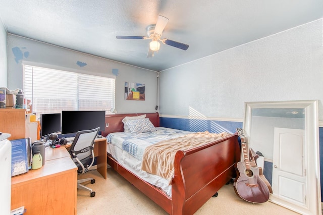 bedroom with ceiling fan and light carpet