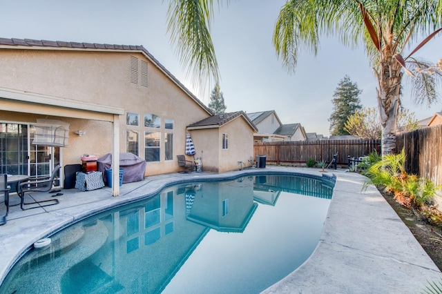 view of swimming pool with area for grilling and a patio