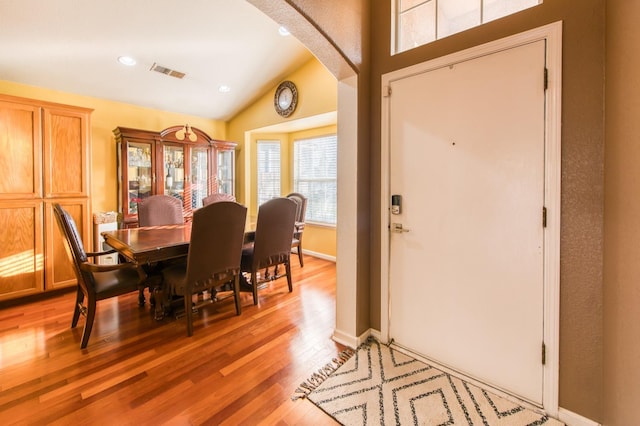 dining space featuring hardwood / wood-style floors and lofted ceiling