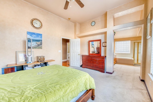 carpeted bedroom featuring a high ceiling and ceiling fan