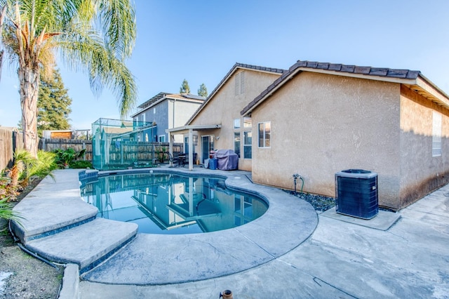 view of swimming pool with central AC and a patio area