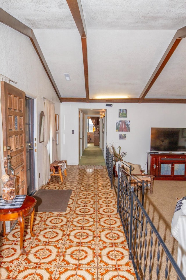 interior space with lofted ceiling with beams, tile patterned floors, and a textured ceiling