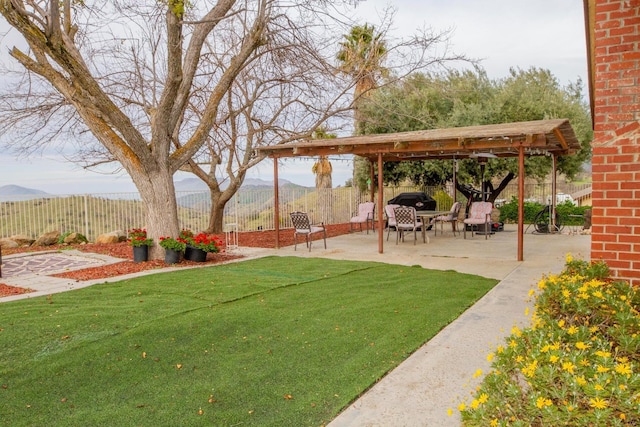 view of yard with a mountain view and a patio