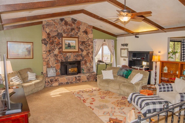 living room featuring ceiling fan, lofted ceiling with beams, a stone fireplace, and carpet flooring