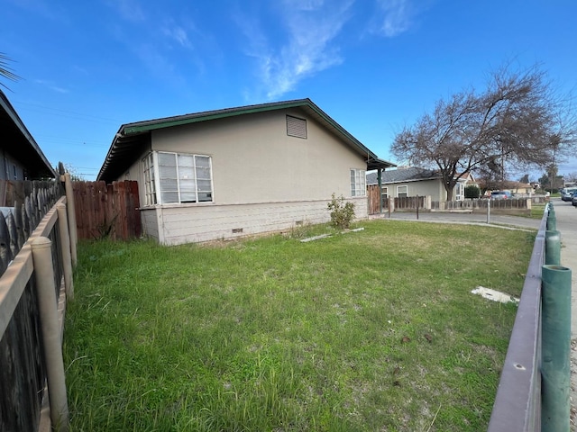 view of property exterior with a yard