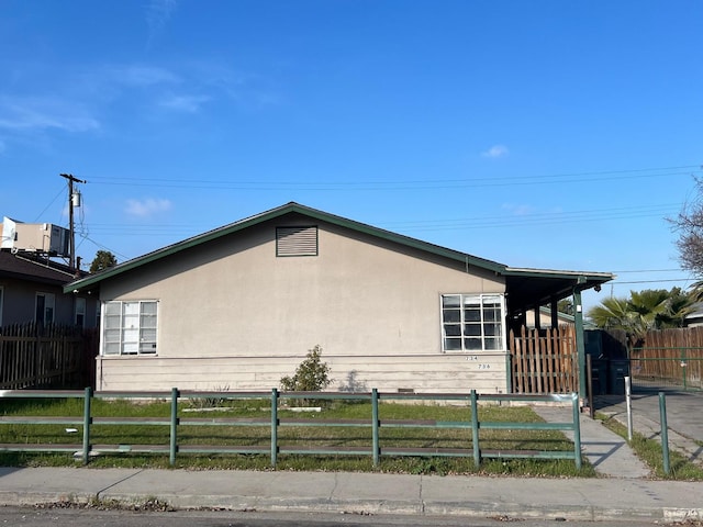 view of side of home featuring central AC