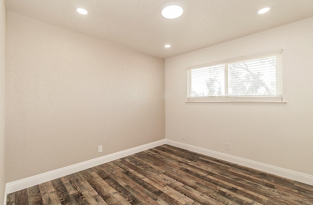 12027 S Brawley Ave, Caruthers, CA 93609 - empty room featuring dark wood-style flooring, baseboards, and recessed lighting