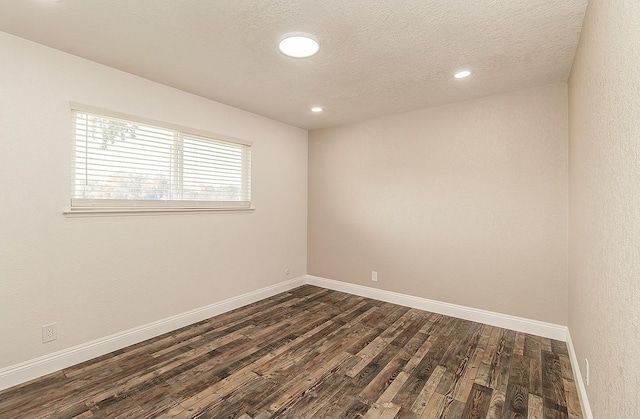 12027 S Brawley Ave, Caruthers, CA 93609 - unfurnished room featuring dark wood-style flooring, baseboards, recessed lighting, and a textured ceiling