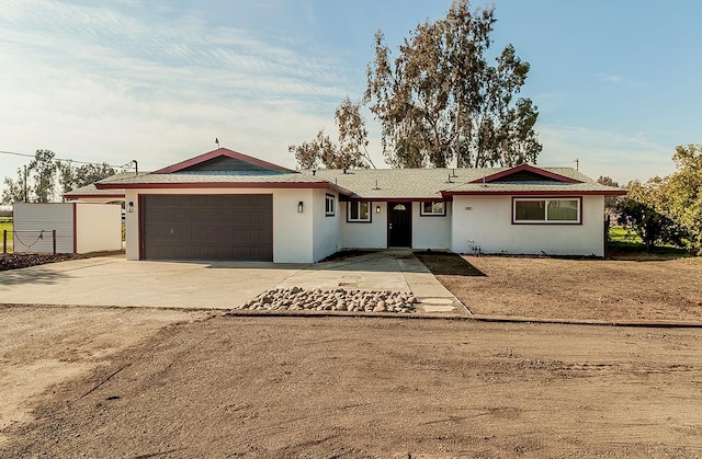 12027 S Brawley Ave, Caruthers, CA 93609 - ranch-style home featuring a garage, concrete driveway, and stucco siding