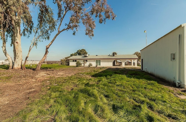 12027 S Brawley Ave, Caruthers, CA 93609 - rear view of property featuring a yard