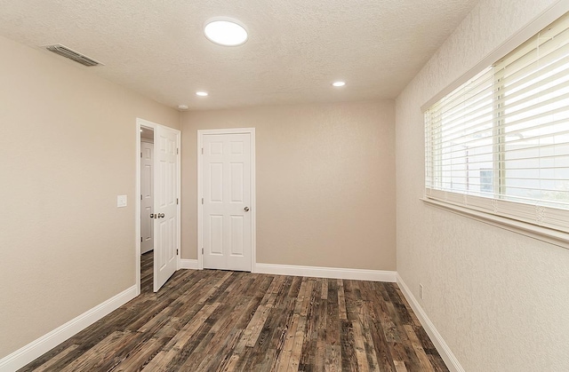 12027 S Brawley Ave, Caruthers, CA 93609 - spare room featuring dark wood-style floors, a textured ceiling, baseboards, and recessed lighting