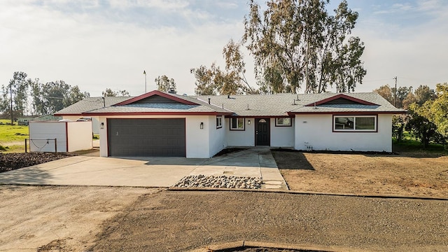 12027 S Brawley Ave, Caruthers, CA 93609 - ranch-style home featuring a garage, stucco siding, and concrete driveway