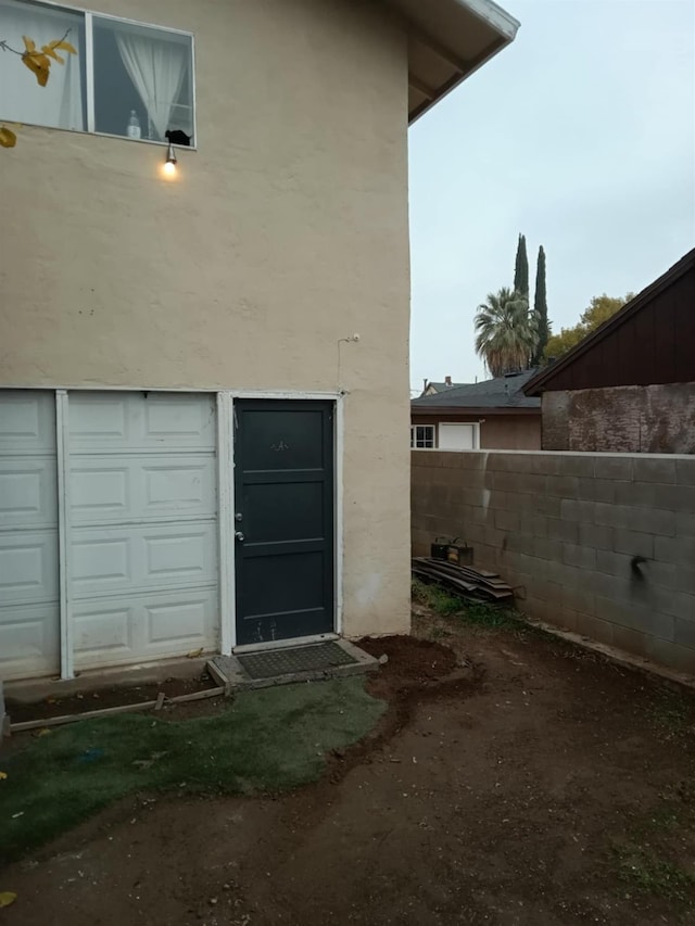 doorway to property with a garage