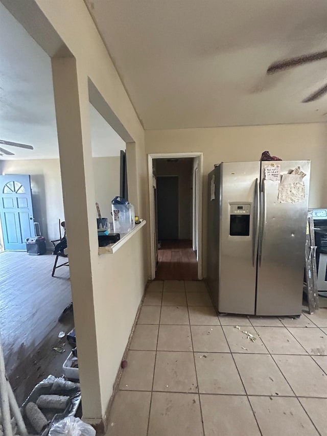 kitchen with stainless steel fridge, light tile patterned floors, and ceiling fan