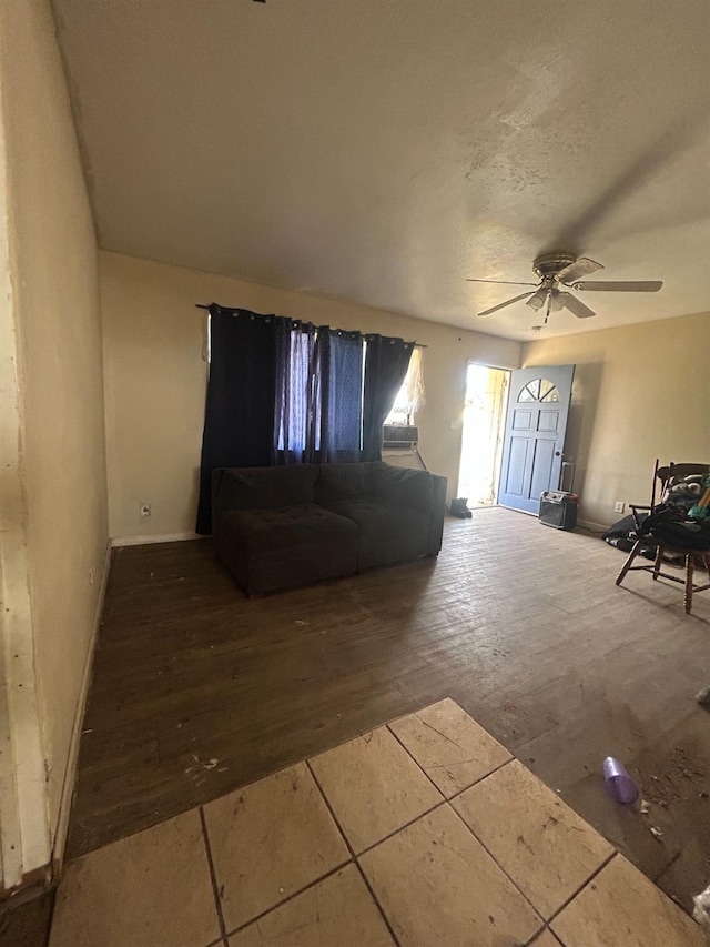 unfurnished living room featuring wood-type flooring and ceiling fan