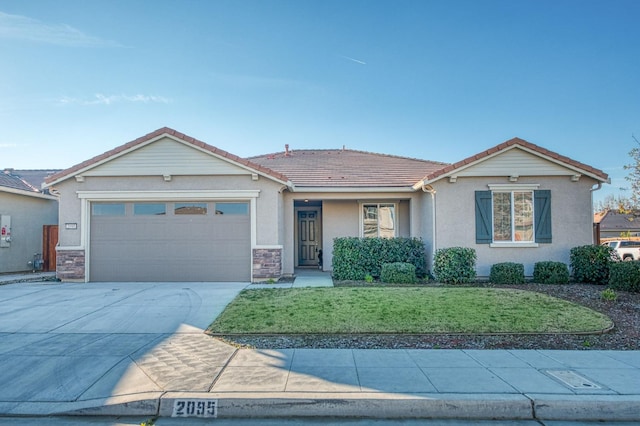 ranch-style home with a garage and a front lawn