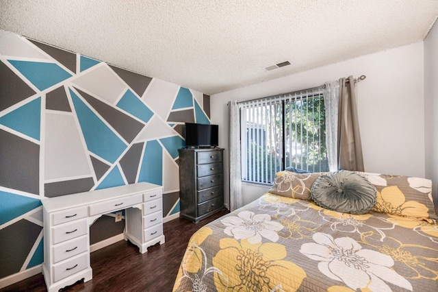 bedroom featuring a textured ceiling and dark hardwood / wood-style floors