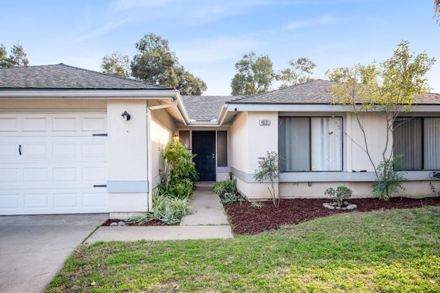 single story home featuring a garage and a front lawn