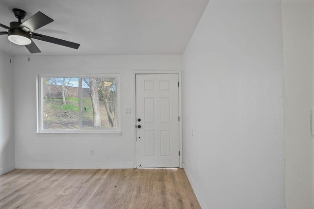 foyer entrance with ceiling fan and light hardwood / wood-style flooring