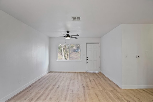 empty room with light wood-style floors, visible vents, ceiling fan, and baseboards