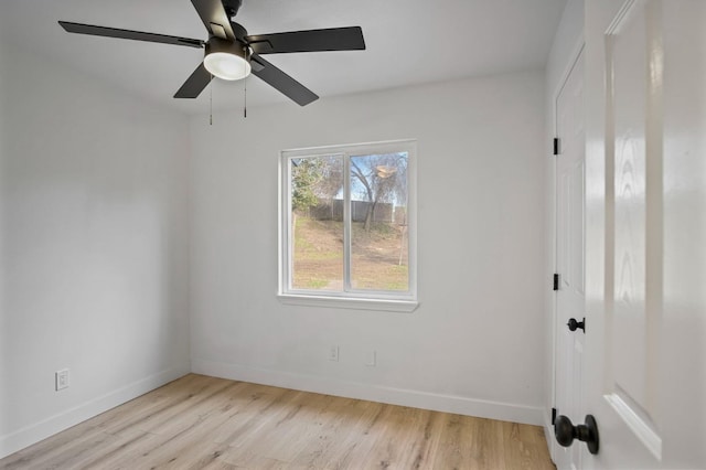 unfurnished room featuring ceiling fan, baseboards, and wood finished floors