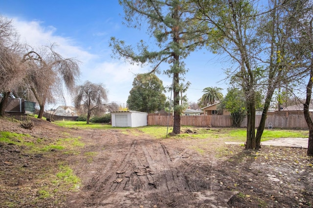 view of yard with a garage and an outdoor structure