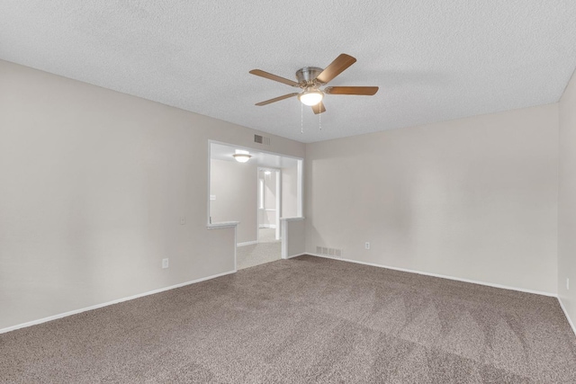 carpeted empty room featuring a textured ceiling and ceiling fan