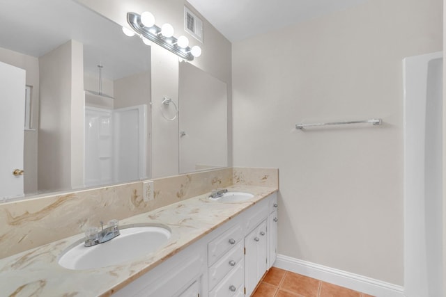 bathroom with tile patterned flooring and vanity