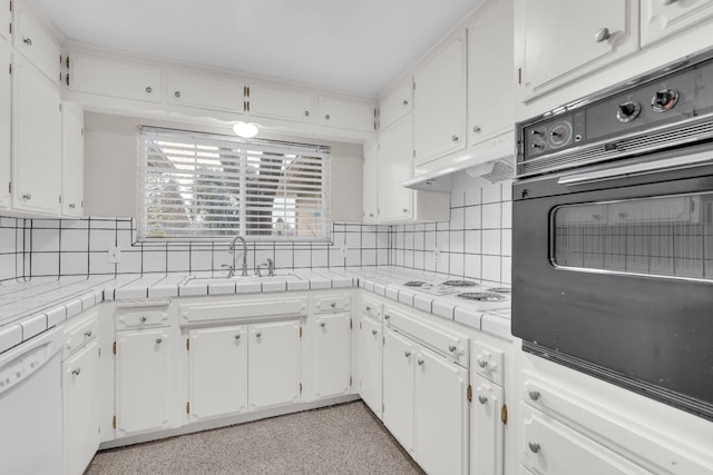 kitchen featuring decorative backsplash, white cabinetry, white appliances, and sink