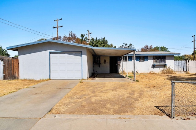 ranch-style house featuring a garage and a carport