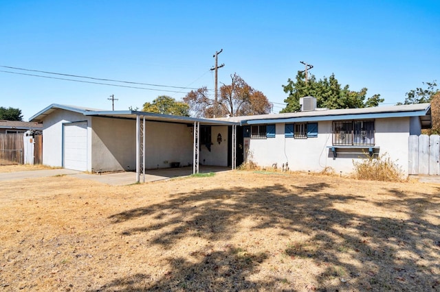 ranch-style home with a garage, central AC, and a front lawn