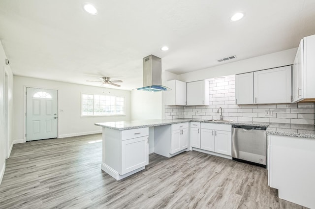 kitchen with sink, stainless steel dishwasher, kitchen peninsula, extractor fan, and white cabinets