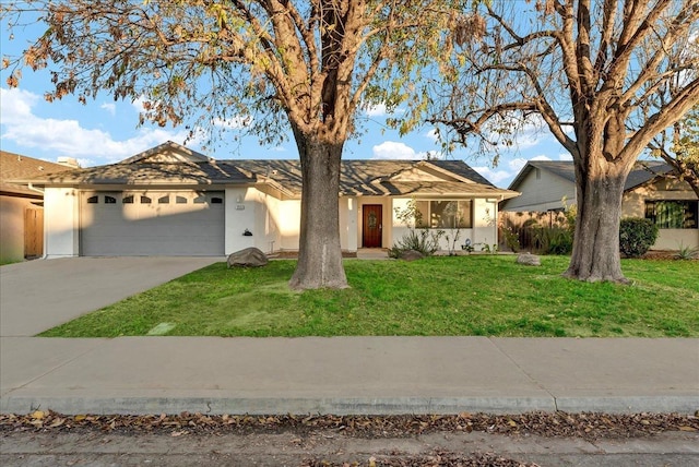 ranch-style home featuring a front lawn, a garage, driveway, and stucco siding