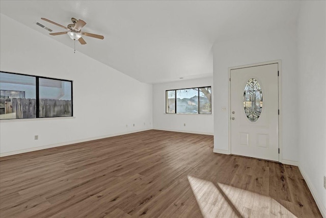 entryway featuring visible vents, ceiling fan, baseboards, lofted ceiling, and wood finished floors