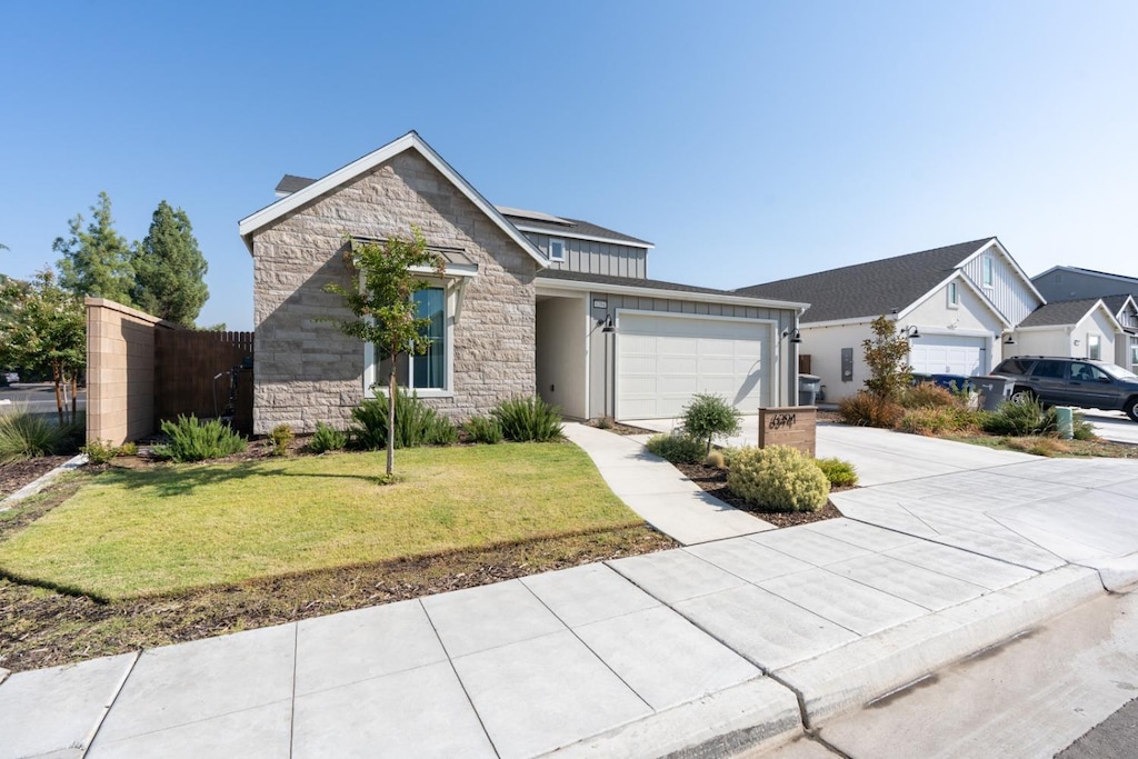 view of front of house with a garage and a front lawn