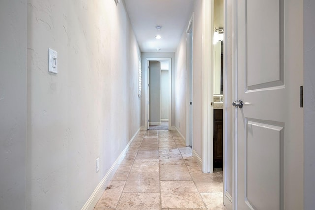 10810 N Matus Ave, Fresno, CA 93730 - corridor featuring baseboards and stone tile flooring