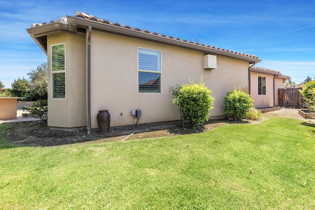 10810 N Matus Ave, Fresno, CA 93730 - rear view of property featuring a lawn, fence, and stucco siding