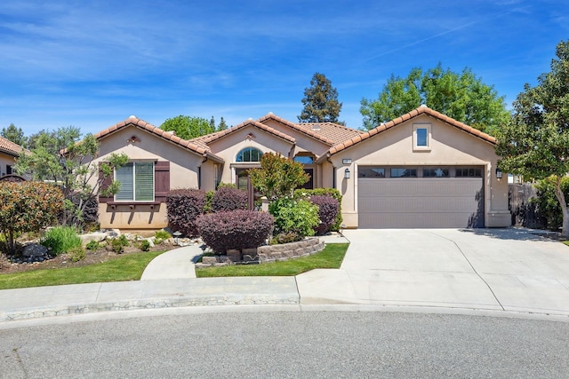 10810 N Matus Ave, Fresno, CA 93730 - mediterranean / spanish home with a garage, driveway, a tile roof, and stucco siding