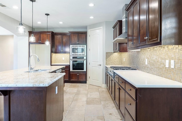10810 N Matus Ave, Fresno, CA 93730 - kitchen featuring appliances with stainless steel finishes, a sink, wall chimney exhaust hood, recessed lighting, and backsplash