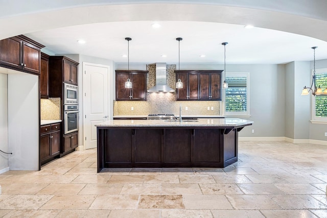 10810 N Matus Ave, Fresno, CA 93730 - kitchen featuring stainless steel appliances, baseboards, wall chimney exhaust hood, and stone tile flooring
