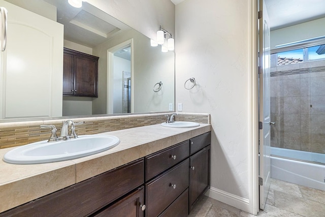 10810 N Matus Ave, Fresno, CA 93730 - bathroom featuring baseboards, a sink, combined bath / shower with glass door, and double vanity