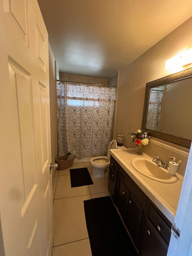 bathroom with a shower with curtain, tile patterned flooring, vanity, and toilet