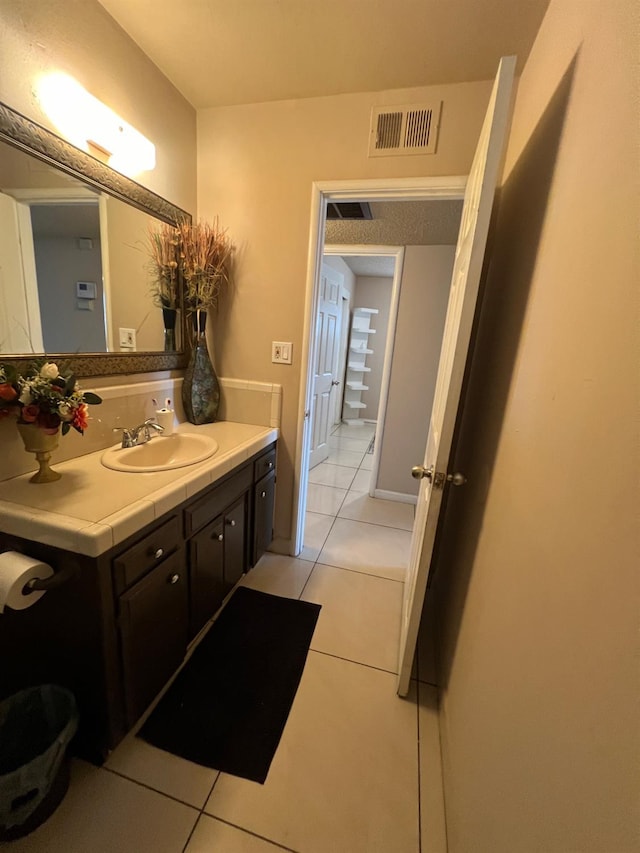 bathroom with tile patterned floors and vanity