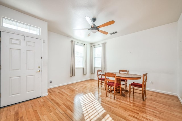 dining space featuring ceiling fan and light wood-type flooring