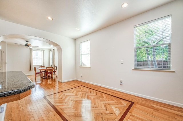 empty room featuring ceiling fan and hardwood / wood-style flooring