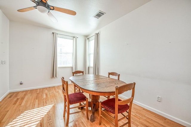 dining area featuring light wood-type flooring and ceiling fan