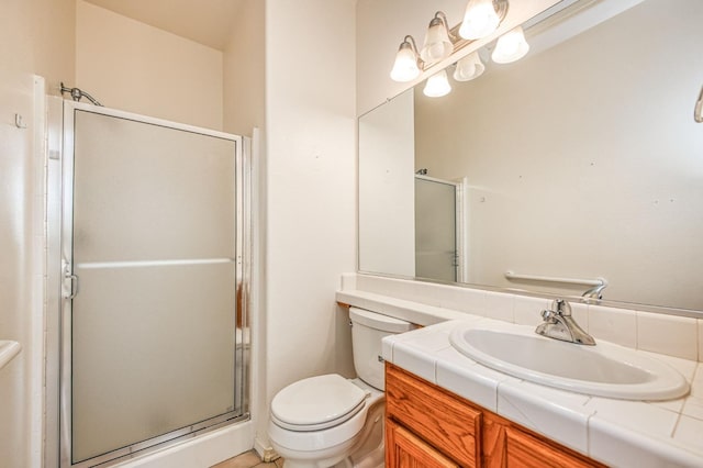 bathroom with vanity, walk in shower, and toilet