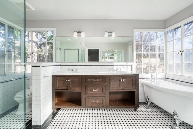 3628 N Van Ness, Fresno, CA 93704 - bathroom with tile walls, healthy amount of natural light, double vanity, a freestanding tub, and a shower stall