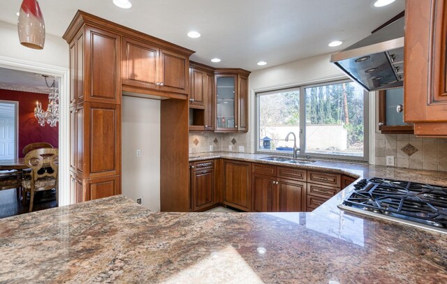 3628 N Van Ness, Fresno, CA 93704 - kitchen featuring wall chimney exhaust hood, brown cabinetry, dark stone counters, and recessed lighting
