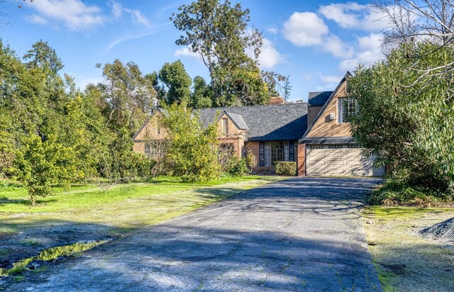 3628 N Van Ness, Fresno, CA 93704 - tudor house with asphalt driveway and an attached garage